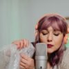 A woman with purple hair performs ASMR using bubble wrap and a microphone.,scripturereel.com